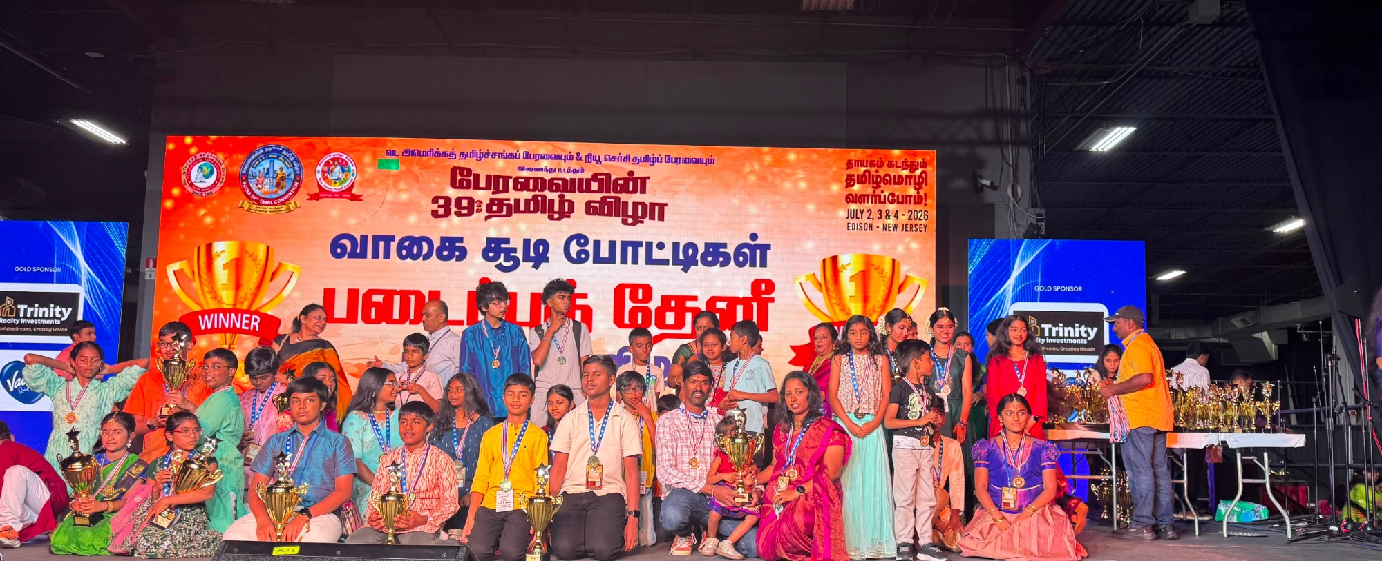 Students on stage with trophies at the Creativity Thenee competition